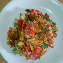 A picture of Fried chicken with veggies.
