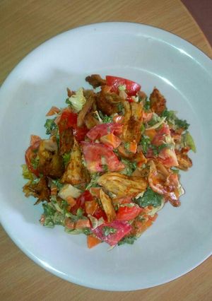 A picture of Fried chicken with veggies.