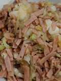 Round cabbage with ham and onion