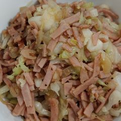 A picture of Round cabbage with ham and onion.