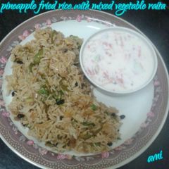 A picture of Pineapple fried rice with mixed vegetable raita.