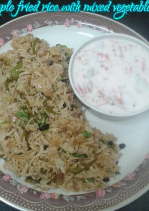 A picture of Pineapple fried rice with mixed vegetable raita.