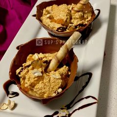A picture of Sweet Curd In Edible Chocolate Bowl.
