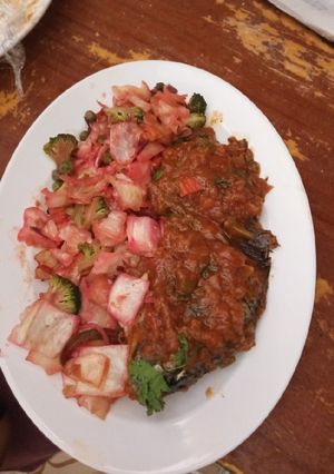 A picture of Grilled fish and Cubed buttered steamed vegetable salad.