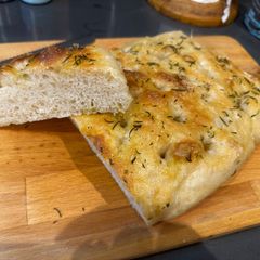 A picture of Worlds Best Traditional Sourdough Focaccia Bread. Olive oil, rosemary and sea salt - WOWWWWW.