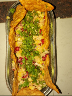 A picture of Salsa with nacho chips.