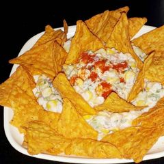 A picture of Mexican corn salad with nachos.