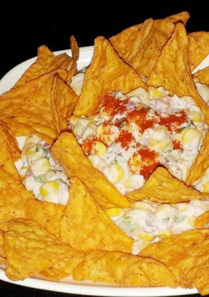 A picture of Mexican corn salad with nachos.