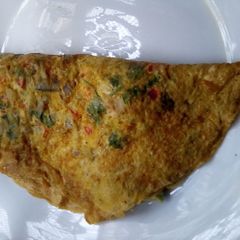 A picture of Turmeric omelette stuffed with fruits.