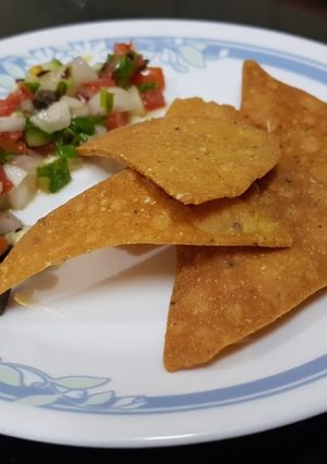 A picture of Nachos with salsa.