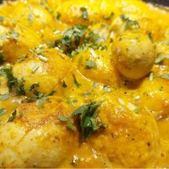 A picture of Egg curry with baby potatoes.