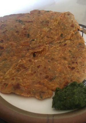 A picture of Mixed vegetable paratha with mint and coriander chutney.