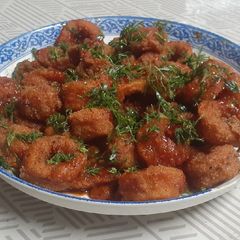 A picture of Squid rings in Schezwan sauce.