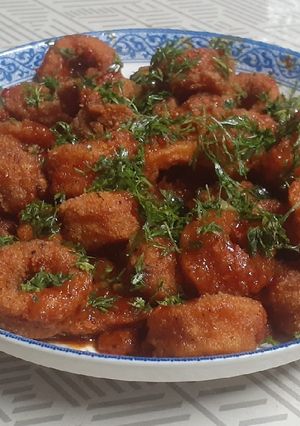 A picture of Squid rings in Schezwan sauce.