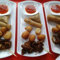 A picture of Puff puff, spring rolls, samosa and fried meat.