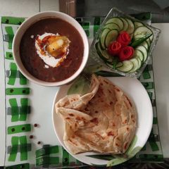 A picture of Dal makhani and malabari Parantha.