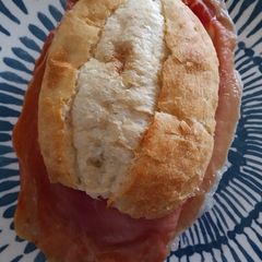 A picture of Cured ham and goats cheese sandwich.