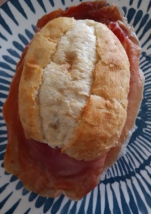 A picture of Cured ham and goats cheese sandwich.