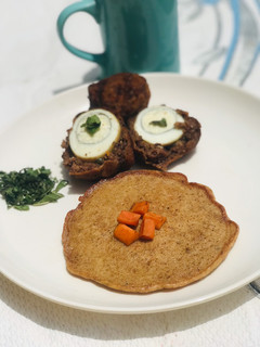 A picture of Fried scotch egg 🥚 with breadcrumb pancake 🥞.