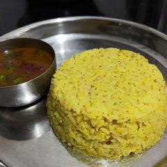 A picture of Huggi gojju/ masala kichidi with sweet and tangy rasam.