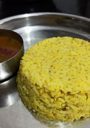 A picture of Huggi gojju/ masala kichidi with sweet and tangy rasam.