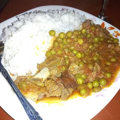 A picture of Rice and greenpeas and meat.
