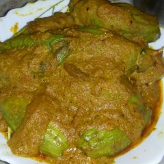 A picture of Potoler dorma (stuffed pointed gourd curry).
