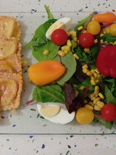 Una foto de Raviolis de roquefort con crema de tomates secos y ensalada