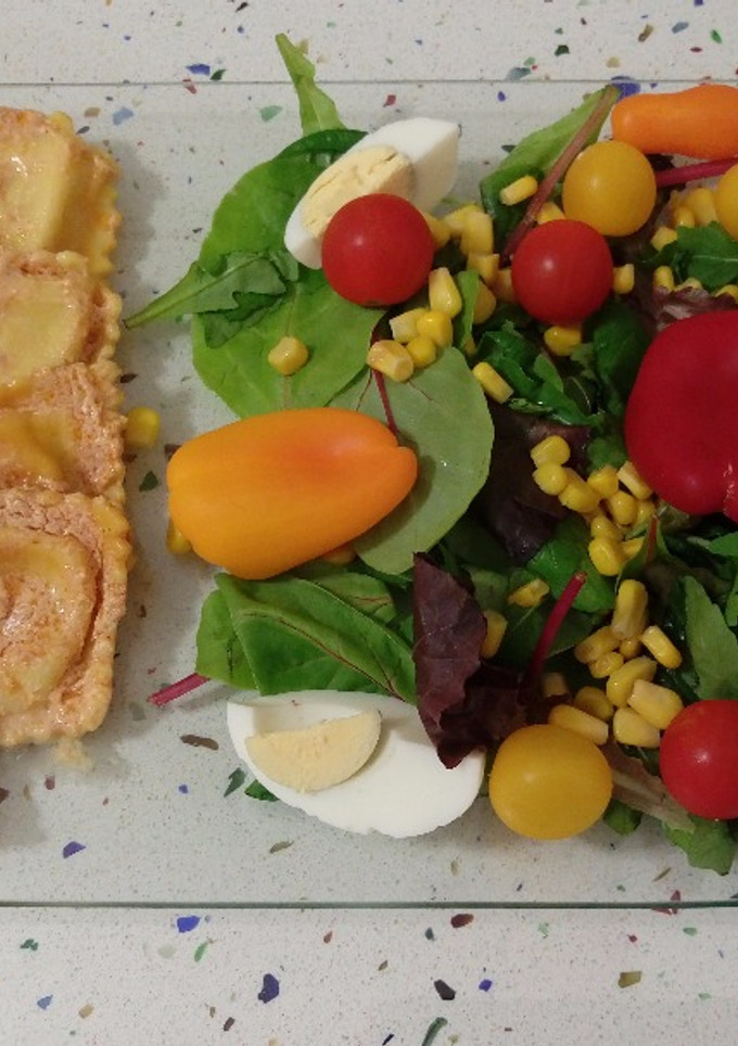 Una foto de Raviolis de roquefort con crema de tomates secos y ensalada