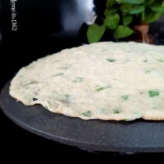 A picture of Persian Saj Flatbread with Scallion Greens.