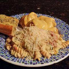 A picture of Brad's chicken sausage pasta w/ tomato, basil, vodka cream sauce.