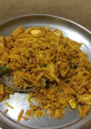 A picture of Chicken and Egg Pulav with Leftover chicken tikka and rice.