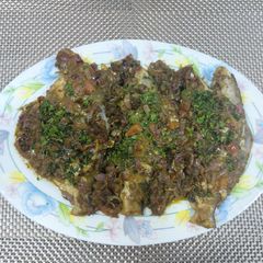 A picture of Stuffed green masala pomfret.
