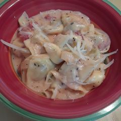 A picture of Tortellini with a Creamy Tomato Basil Sauce.