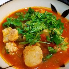 A picture of Sea scallops in tomato onion soup.