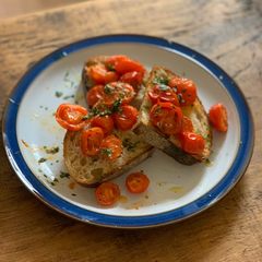 A picture of Roast tomatoes on sourdough.