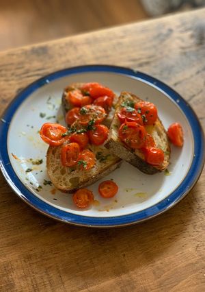 A picture of Roast tomatoes on sourdough.