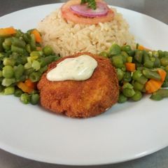 A picture of Fish fillet in breadcrumbs,braised rice and mixed vegetables.