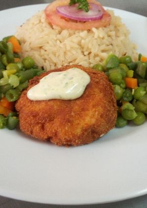 A picture of Fish fillet in breadcrumbs,braised rice and mixed vegetables.