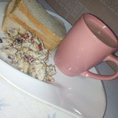 A picture of Masala tea and scrambled egg with sardines.