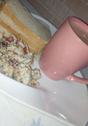 A picture of Masala tea and scrambled egg with sardines.