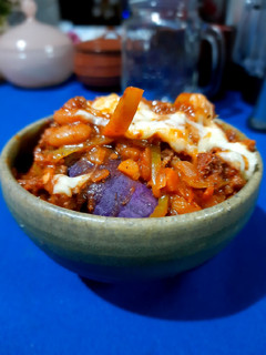 A picture of Steamed sweet potato with chilli con carne.