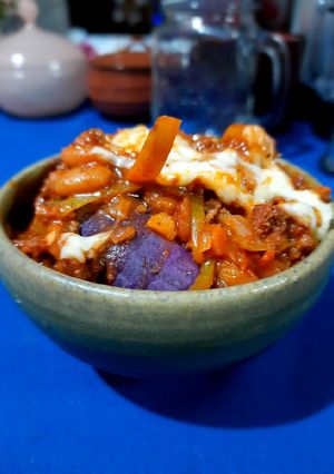 A picture of Steamed sweet potato with chilli con carne.