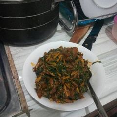 A picture of Ugba with garden leaves.