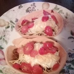 A picture of Tacos in a taco 🌮 bowl.