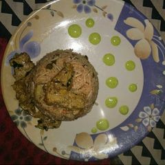 A picture of Soya Chaap Biryani with green chutney.