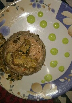 A picture of Soya Chaap Biryani with green chutney.