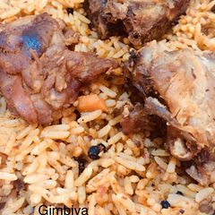 A picture of Jellof Rice with chicken.