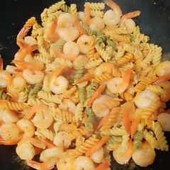 A picture of Shrimp and noodles with garlic sauce.