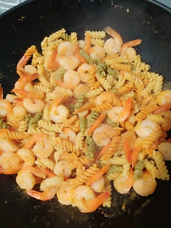 A picture of Shrimp and noodles with garlic sauce.